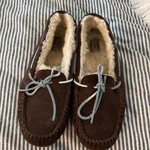 Ugg slippers. They are chocolate colored with a blue leather bow.